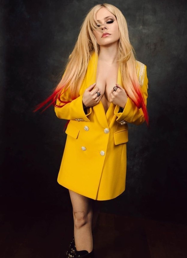 What do you think of Avril Lavigne wearing more revealing clothes? Do you think it has a professional purpose or sexualizing purpose?