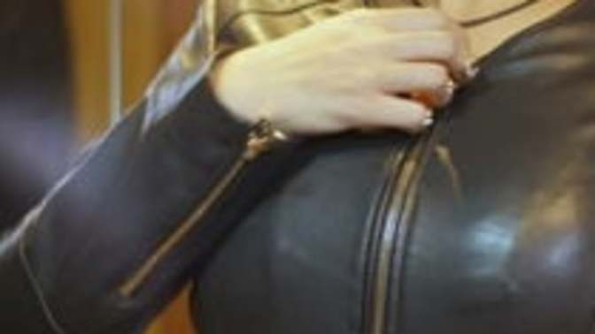 Why do some women keep adjusting their jacket to cover their boobs?