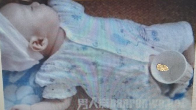 East Asian/ Southeast Asian language speakers, what what do these words say and what TF is this photo of a baby about? What is the cup doing?