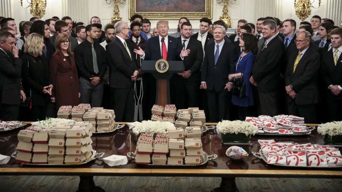 What does Biden snack on in bed at night as he watches the news?