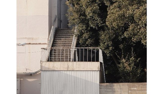 Why do some people take photos of everyday objects when they travel?