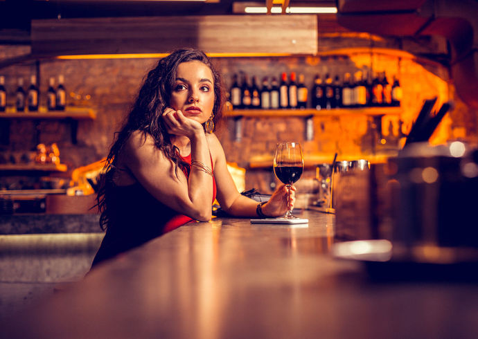 What do you think when you see a woman drinking alone at a bar?