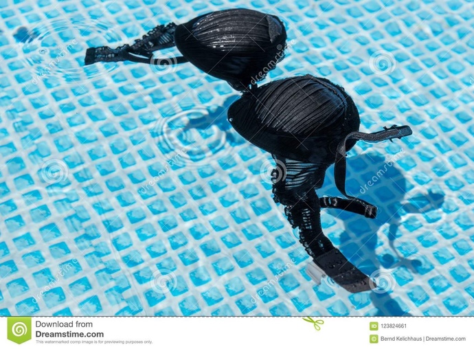 Can a girl just decide to remove her bra to get more comfortable while swimming around kids and families?