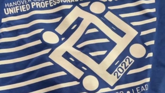 Did this t shirt logo created by a teacher was done by malice or had a subliminal meaning to it to project to the students and other educators?