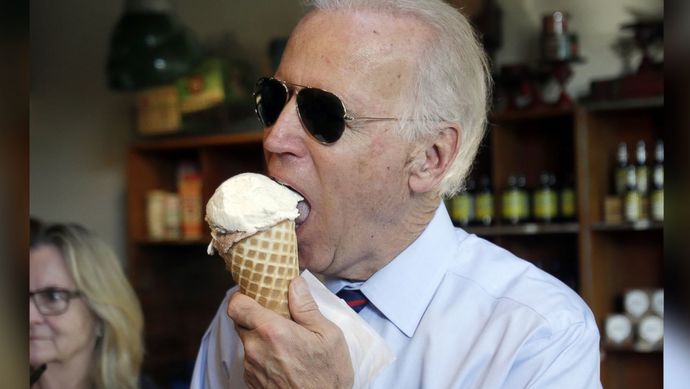 Biden wearing sunglasses in a dark room