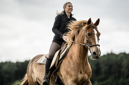Why do so many women love horseback riding?