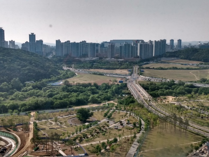 The bridge is in the center-right, and the river and mountain is on the left. The city in the background.