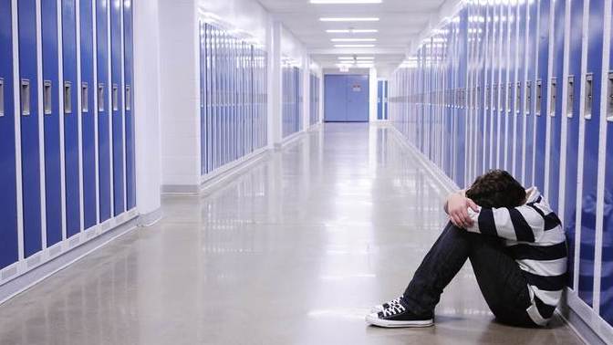How do I help my younger brother who is getting bullied at school by words and starting to believe them?