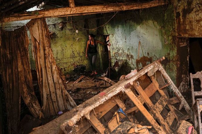 Oct. 10, 2022 Las Tejerias, Venezuela Woman stands in her home which was damaged after a fatal landslide.