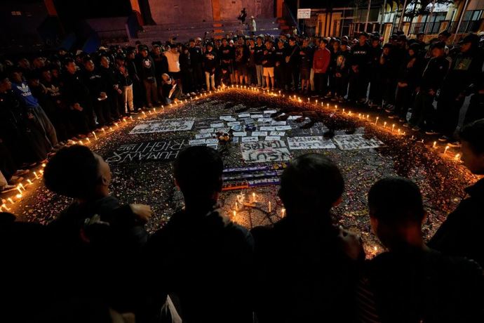 Oct. 3, 2022 Malang, Indonesia People pray for the victims of a stampede which left over 100 dead after a soccer match.