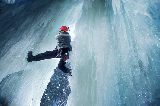 A man ice climbs a frozen waterfall in western Maryland. 2001.