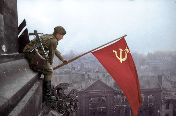 Soldier Waves A Soviet Flag Over Berlin, 1945