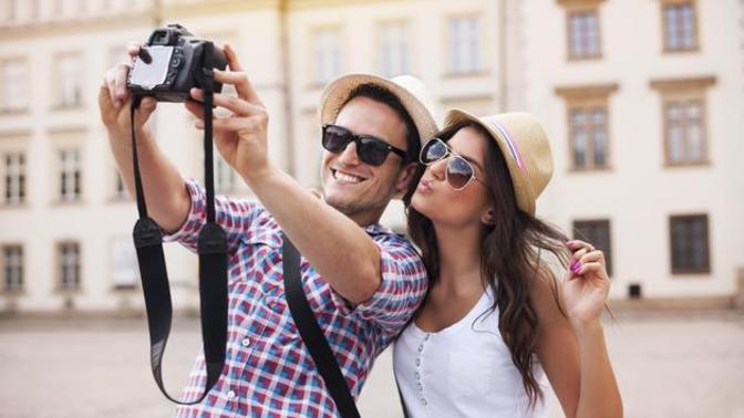 What's the reason why people like to take photos with tourists?