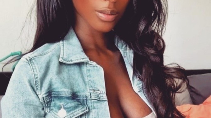 Why is she receiving backlash from black men for dating a white man?