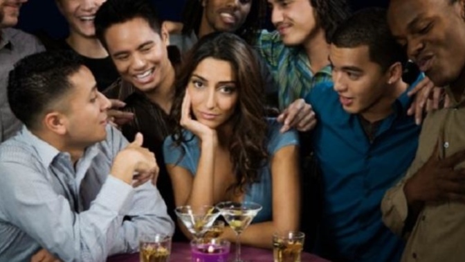 Why do women get surrounded by men then after she sees you then walks up to you then talking to you?