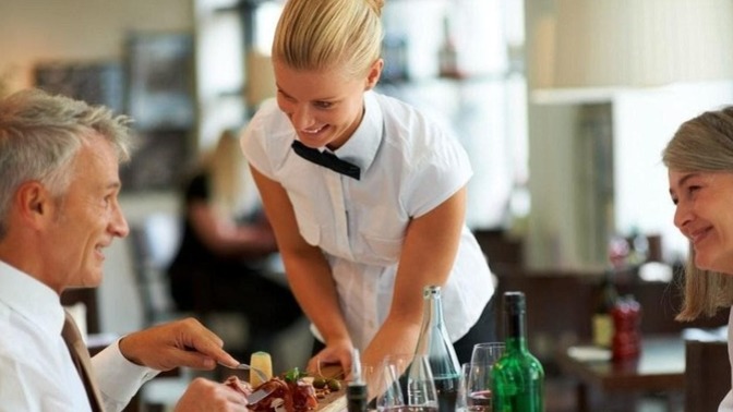 Why are restaurant workers compensated by tipping?