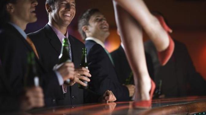 Is it normal to feel insecure about my boyfriend going to a strip club for a stag do?