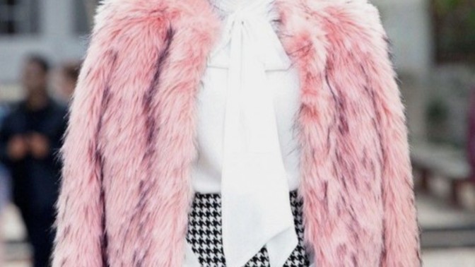 Why do people wear fur coat on their shoulder like this in the picture?