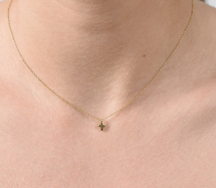 Which one of these earrings would look best with this tiny cross necklace?