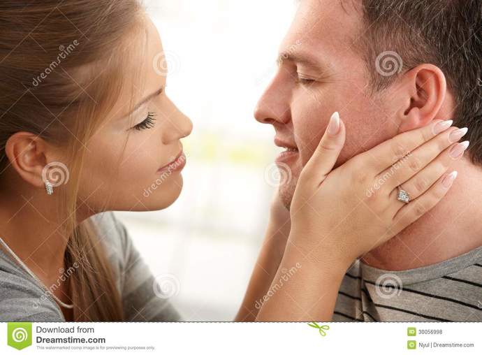 Why do men like to cup the girls face before kissing?