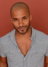 An older version of Ricky Whittle so salt and pepper the facial hair.