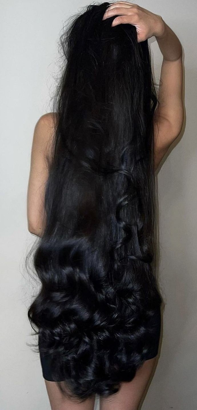 Long, black and curled at the ends 