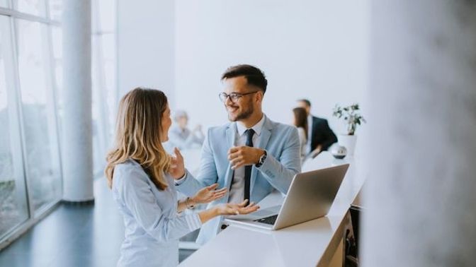 Best ways to start up a conversation with a woman at work, without coming off as being too aggressive?