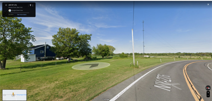 House in Canada; road in the USA. The fence is about 4 feet tall and made of cheap T-posts.