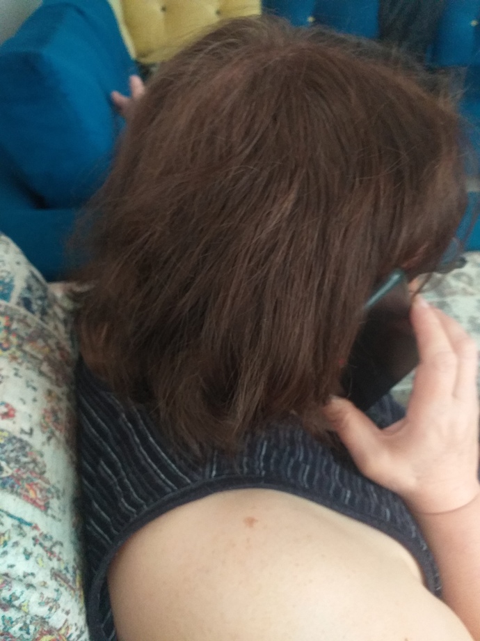 I know it is such a weird question to ask, but we bleached and dyed my mums hair to light brown. Does it look slightly red to you?
