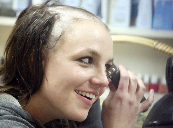 Britney Spears giving herself a buzz cut. The dummy didn't know the buzz cut was supposed to be down below.