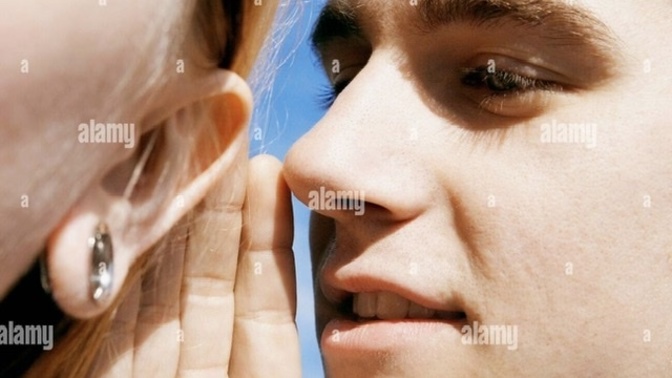 What does it mean when a guy sneaks up behind a girl and whispers in her ear?