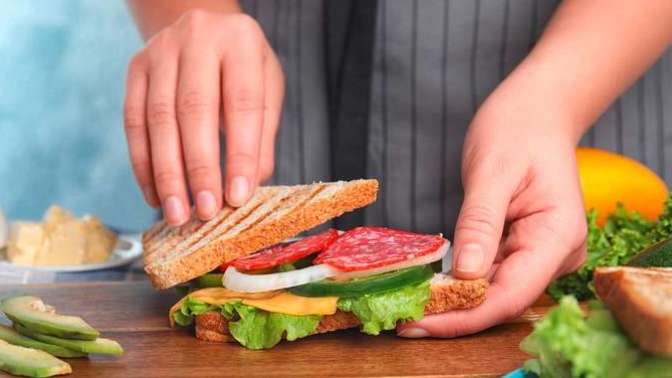 Who should go make a sandwich if asked while one stays sitting on the couch watching TV, the wife or husband and why?