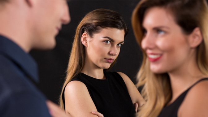 Why are women getting upset and jealous when a guy she knows is flirting or getting flirted with other girls?