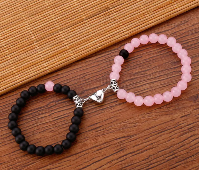 Black Bracelet with on pink bead & Pink bracelet with one black bead. Silver magnet heart