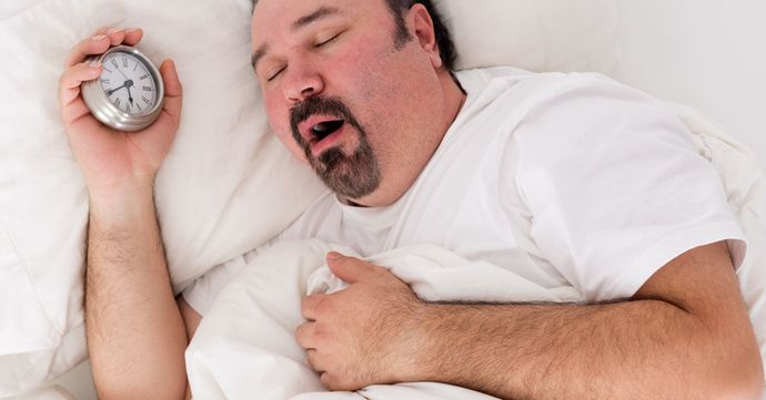 Man sleeping with alarm clock