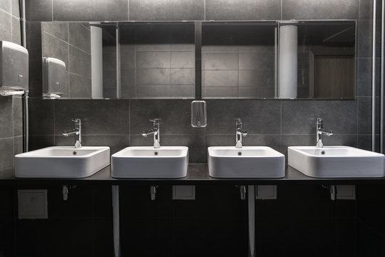 Public bathroom with only overhead lights
