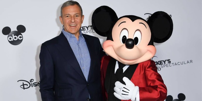 One of these men is an idiot in a suit. The other one is Mickey Mouse.