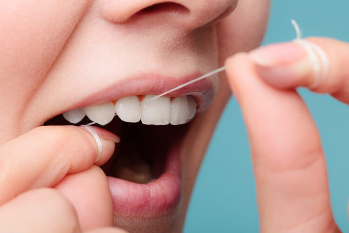 How do you remove FOOD PARTICLES from between your TEETH?