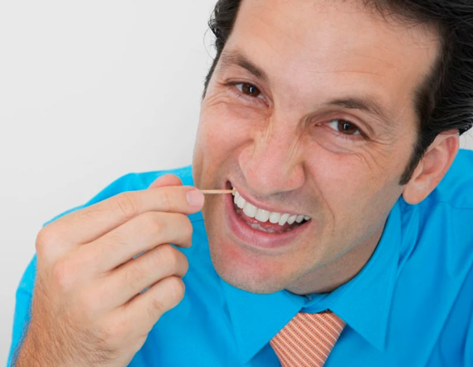 How do you remove FOOD PARTICLES from between your TEETH?