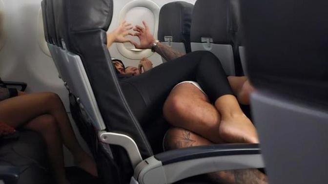 Do you think this couple snuggling barefoot like this on a plane is inappropriate?