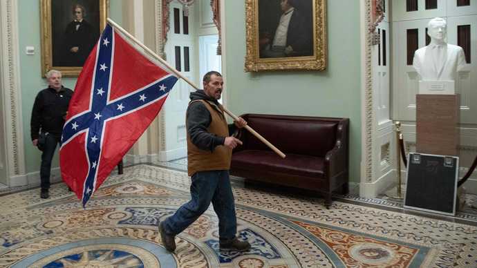 What should be done about the members of Congress that waved the Ukrainian flag in the US Capitol after passing the aid package to Ukraine?