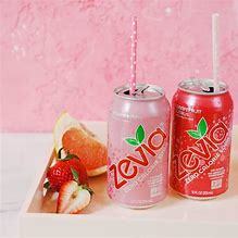 Opened cans of Zevia soda with straws