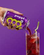 Grape flavored Poppi being poured in a glass