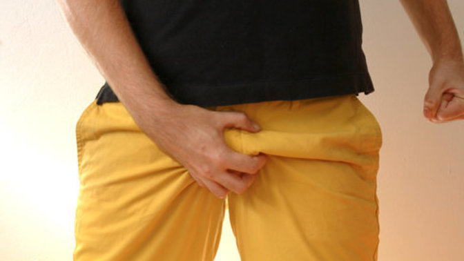 What does it mean when a guy pinches his groin around a girl?