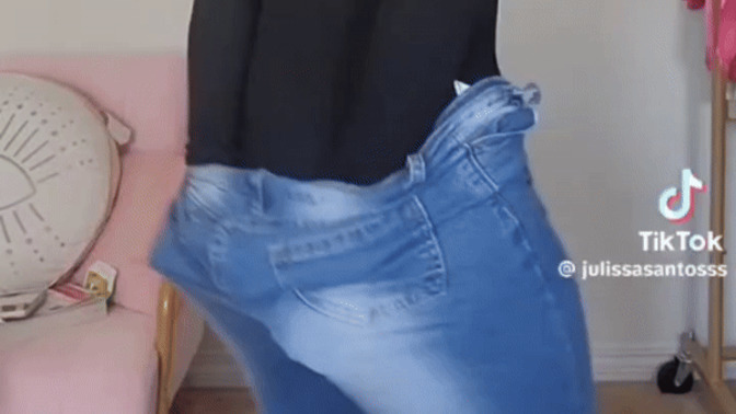 Why do women "bow" when pulling up their pants?