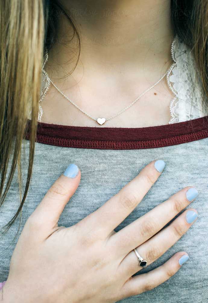 Why does my wife often tap her boobs like a fidget?