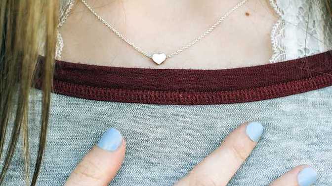 Why does my wife often tap her boobs like a fidget?