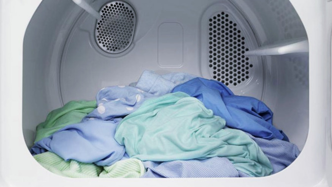 How long should you wait before removing another person's clothes from the Dryer after completion?