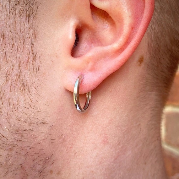 Is it gay for men to wear hoop earrings?