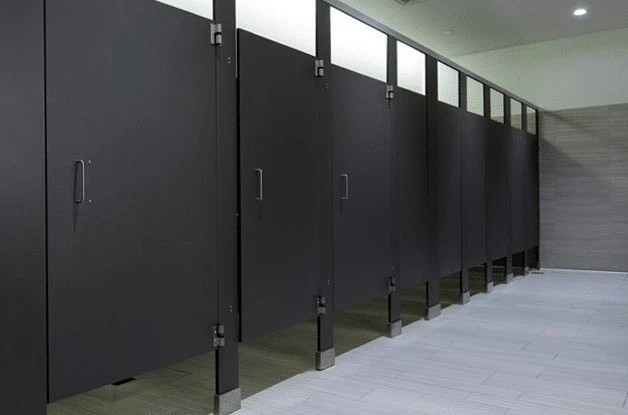 Why does a womans bathroom have more bathroom stalls and room than the men bathroom does?